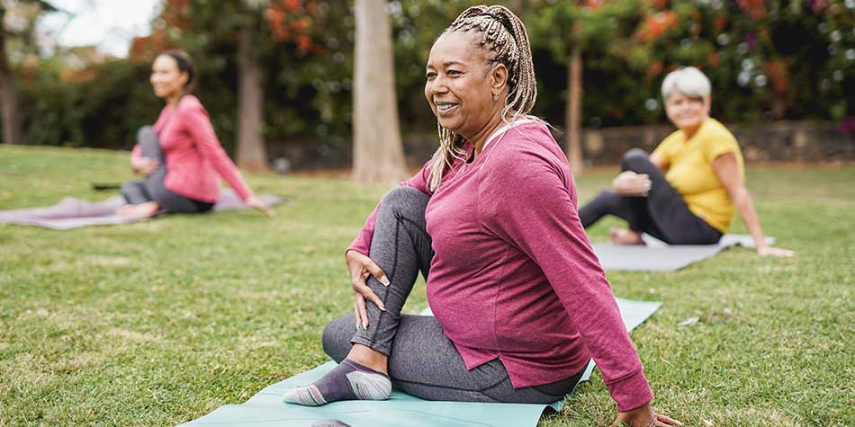 African-American woman sitting on a yoga mat